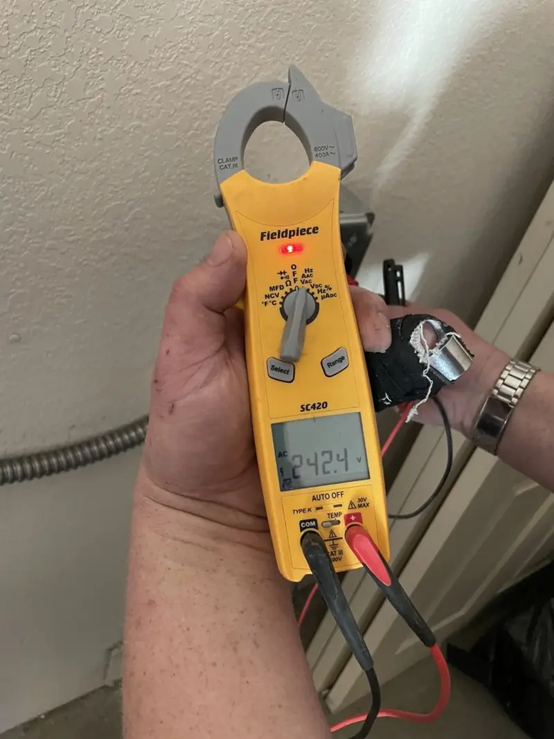 Voltage testing with clamp meter during Electrical Installation Services in Enoch